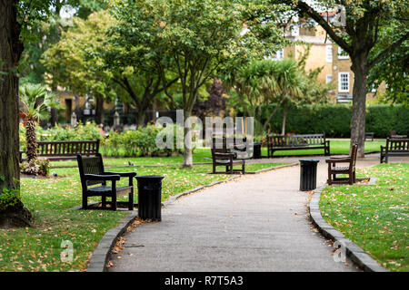 London, UK - September 16, 2018: Empty path in green St Luke's Gardens Park in Chelsea, landscape view during green autumn in United Kingdom, nobody Stock Photo