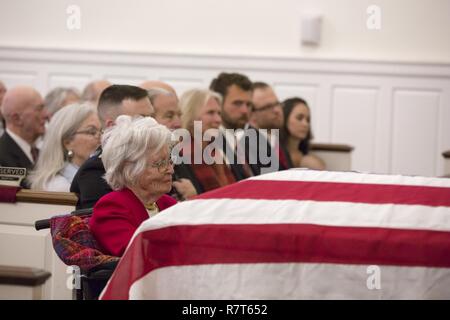 Annie Glenn, wife of of Retired Marine Col. John H Glenn Jr., grieves during her husbands funeral service at the Old Post Chapel, Ft. Myer, Arlington, Va. April 6, 2017. Glenn passed away Dec. 8, 2016. Glenn was a U.S. Marine aviator who flew 149 combat missions during World War II and the Korean War. He later became a NASA astronaut and was the first man to orbit the earth aboard the “Friendship 7” in 1962. He was then elected to the U.S. Senate for the state of Ohio in 1974 and served four consecutive terms. Stock Photo