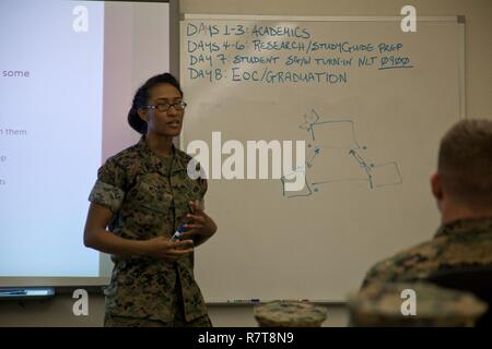 U.S. Marine Corps Sgt. Estrella J. Moore, an instructor assigned to the Tactical Signals Intelligence Operators Course, Marine detachment Goodfellow, gives a period of instruction at Joint Airforce Base Goodfellow, Texas, March 24, 2017. The mission of Marine Detachment Goodfellow is to train Marines in the occupational fields of Fire Protection and Signals Intelligence for the Fleet Marine Force. Stock Photo