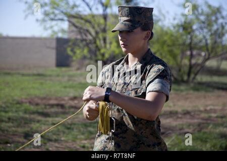 U.S. Marine Corps Pfc. Sydney I. Munn, a student assigned to the Tactical Signals Intelligence Operators Course, Marine detachment Goodfellow, sets up a 8 Meter Collapsable Mast Assembly at Joint Airforce Base Goodfellow, Texas, March 24, 2017. The mission of Marine Detachment Goodfellow is to train Marines in the occupational fields of Fire Protection and Signals Intelligence for the Fleet Marine Force. Stock Photo