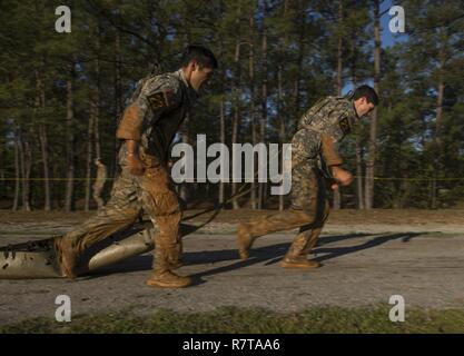 U.S. Army Staff Sgt. Ricardo Orduna and 1st Lt. Colton Barber, Rangers with the 25th Infantry Division, pull a litter during the Best Ranger Competition 2017 in Fort Benning, Ga., April 7, 2017. The 34th annual David E. Grange Jr. Best Ranger Competition 2017 is a three-day event consisting of challenges to test competitor's physical, mental, and technical capabilities. Stock Photo