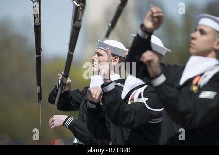 WASHINGTON, DISTRICT OF COLUMBIA - Airman Ryan Daily, a sailor with the United States Navy's Ceremonial Guard competes during the Joint Service Drill Team Exhibition April 08, 2017, at the Jefferson Memorial in Washington, D.C. Drill teams from all four branches of the U.S. armed forces and the U.S. Coast Guard competed in a display of  skills at the event that celebrated U.S. military heritage at the National Cherry Blossom Festival.     Members of the Navy Ceremonial Guard participate in some of our nation’s most prestigious ceremonies, including Presidential inaugurations and arrival ceremo Stock Photo