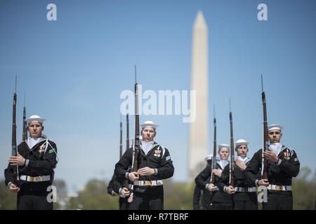 WASHINGTON, DISTRICT OF COLUMBIA - Sailors from the United States Navy's Ceremonial Guard competes during the Joint Service Drill Team Exhibition April 08, 2017, at the Jefferson Memorial in Washington, D.C. Drill teams from all four branches of the U.S. armed forces and the U.S. Coast Guard competed in a display of  skills at the event that celebrated U.S. military heritage at the National Cherry Blossom Festival.     Members of the Navy Ceremonial Guard participate in some of our nation’s most prestigious ceremonies, including Presidential inaugurations and arrival ceremonies for foreign off Stock Photo