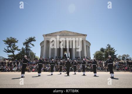 WASHINGTON, DISTRICT OF COLUMBIA - Sailors from the United States Navy's Ceremonial Guard competes during the Joint Service Drill Team Exhibition April 08, 2017, at the Jefferson Memorial in Washington, D.C. Drill teams from all four branches of the U.S. armed forces and the U.S. Coast Guard competed in a display of  skills at the event that celebrated U.S. military heritage at the National Cherry Blossom Festival.     Members of the Navy Ceremonial Guard participate in some of our nation’s most prestigious ceremonies, including Presidential inaugurations and arrival ceremonies for foreign off Stock Photo