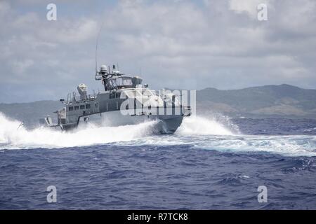 A MK VI patrol boat, assigned to Coastal Riverine Group (CRG) 1 Detachment Guam, maneuvers off the coast of Guam April 6, 2017. CRG 1 Detachment Guam is assigned to Commander, Task Force 75, which is the primary expeditionary task force responsible for the planning and execution of coastal riverine operations, explosive ordnance disposal, mobile diving and salvage, engineering and construction, and underwater construction in the U.S. 7th Fleet area of operations. Stock Photo