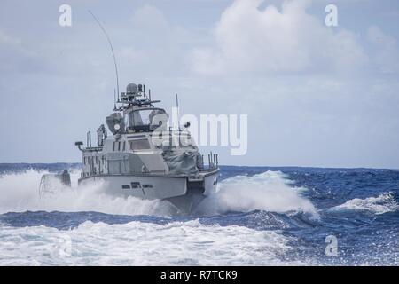 A MK VI patrol boat, assigned to Coastal Riverine Group (CRG) 1 Detachment Guam, maneuvers off the coast of Guam April 6, 2017. CRG 1 Detachment Guam is assigned to Commander, Task Force 75, which is the primary expeditionary task force responsible for the planning and execution of coastal riverine operations, explosive ordnance disposal, mobile diving and salvage, engineering and construction, and underwater construction in the U.S. 7th Fleet area of operations. Stock Photo