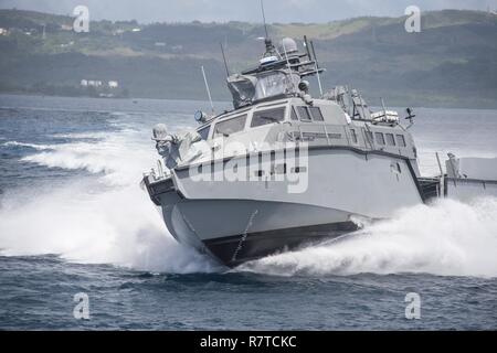 A MK VI patrol boat, assigned to Coastal Riverine Group (CRG) 1 Detachment Guam, maneuvers off the coast of Guam April 6, 2017. CRG 1 Detachment Guam is assigned to Commander, Task Force 75, which is the primary expeditionary task force responsible for the planning and execution of coastal riverine operations, explosive ordnance disposal, mobile diving and salvage, engineering and construction, and underwater construction in the U.S. 7th Fleet area of operations. Stock Photo