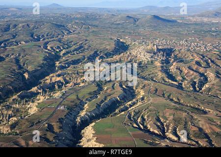 Aerial view of the city of Uchisar with its castle hill in Cappadocia, Turkey. Uchisar has a lot of cave houses built into the soft tufa stone. Stock Photo
