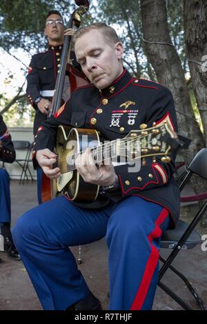 U.S. Marine Corps Sgt. Ulrik Merstrand, a critical skills operator with 1st Marine Raider Battalion plays before the 1st Marine Division Band 9th annual concert at the California Center for the Arts, Escondido, Calif., April 5, 2017.The performance displayed the Marine Corps' commitment to musical excellence and to the community while performing traditional military pieces from the World War I era. Stock Photo