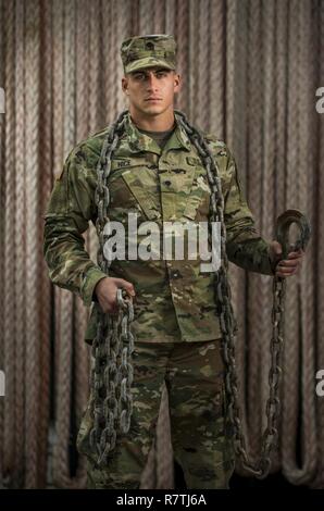 Spc. Dylan Nice, a U.S. Army Reserve watercraft engineer Soldier from the 949th Transportation Company, a unit which specializes in watercraft operations, cargo and watercraft engineering, poses for a series of portraits on board a Logistics Support Vessel in Baltimore, Md., on April 7-8, 2017. Stock Photo