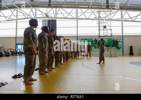 U.S. Army Staff Sgt. Maria Acuna, with Allied Forces Northern Europe (AFNORTH) Battalion, main instructor, gives a safety briefing to Soldiers and Airmen before they pass the clinch drill, during which they have to hold their opponent in order to stop incoming punches, for a combatives level one class taught on Chièvres Air Base, Belgium, March 22, 2017. Stock Photo