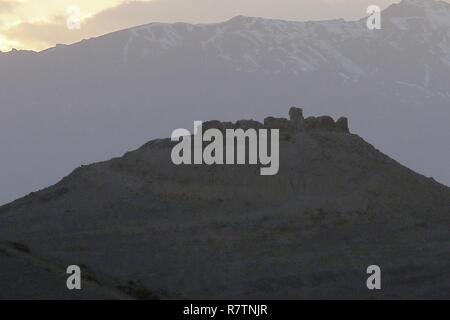 The sunsets behind the ruins of an outpost of Alexander the Great as seen from Advising Platform Lightning Apr. 2, the ruins are just one example of the history of Afghanistan that is near Gardez, Afghanistan. Stock Photo