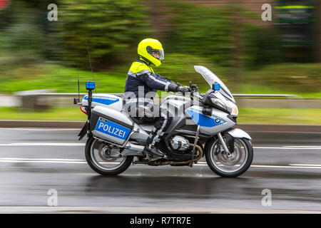 Policeman wearing a yellow helmet on a motorcycle, police motorcycle patrol of the NRW Police, Germany Stock Photo