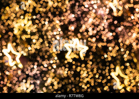 de focused glittering star lights of Christmas Tree Bokeh background Stock Photo