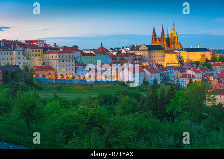 Prague Hradcany, early evening view from above the Petrin Park treeline towards the Hradcany Castle district in Prague, Czech Republic. Stock Photo
