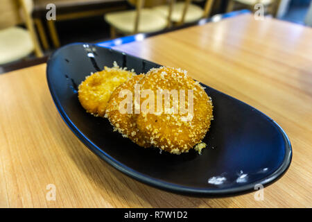 Three Chinese Orange Colored Pumpkin Cake Garnished with Crumbs Stock Photo