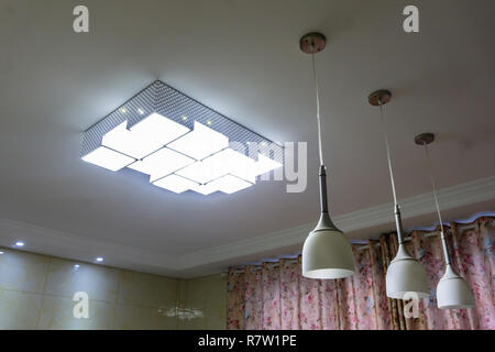 Rectangular Four Times Three Interior Ceiling Chandelier Switched On Stock Photo