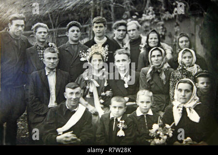 Vintage photo of group of people on wedding. Black and white old photography of newlyweds with people. Ukrainian wedding circa 1960. Vintage photo of  Stock Photo