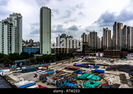 Shanghai Multi Level Highrise Apartment Building with Cloudy Rainy Sky Background with Construction Site Stock Photo
