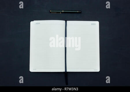 Office dark table. Empty booklet layout, brochure, diary, business portfolio mockup design template on black background. top view, copy Stock Photo
