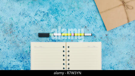 concept of recording your daily affairs on your desktop. Notepad on a blue abstract background. Copy space layout. place for text. Stock Photo