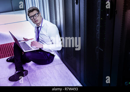 Pleasant handsome man using his laptop for work Stock Photo