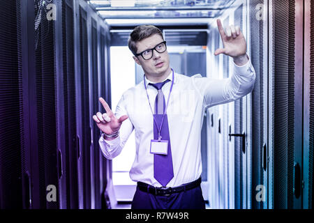 Intelligent handsome young man using newest technologies Stock Photo