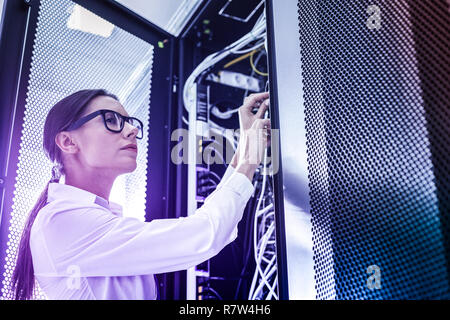 Serious nice young woman being at work Stock Photo