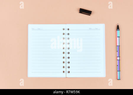 Notepad for text on pink table with copy space. Education and office concept Stock Photo
