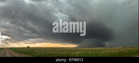 Panoramic view of a supercell thunderstorm over the high plains in Oklahoma with a dramatic green sky