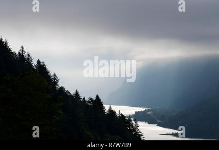 Picture of storm clouds filtering the morning sun rays on a cold wet day in the Columbia River Gorge Stock Photo