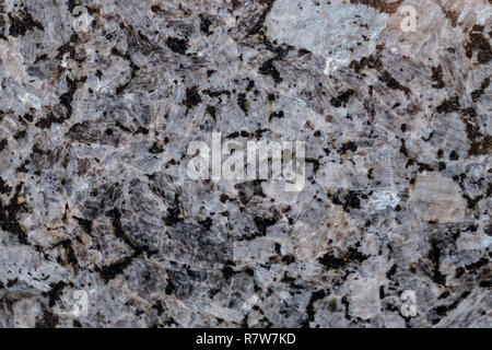 Natural stone. Pink granite. Black Granite. Grey Granite. Facing material. Granite texture. Bright hard granite rock texture. Granite stone background Stock Photo