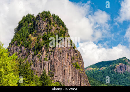 Beacon Rock on the Washington side of the Columbia River Gorge.  A trail winds it's way up to the basalt rock top. Stock Photo