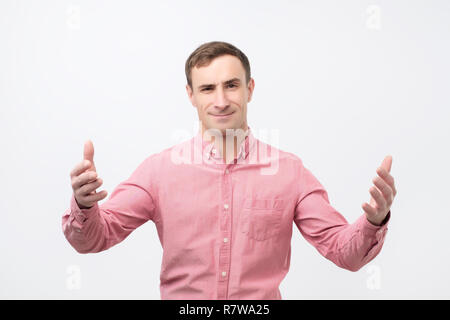 Argue, arguing concept. Young emotional surprised man looking at camera. Stock Photo