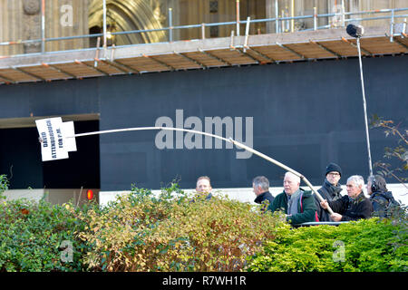 London, UK. 11th December 2018. Campaigner Stuart Holmes tries to emulate anti-Brexit protesters with a long pole for his 'David Attenborough for Prime Minister' message, but needs a stronger pole. Credit: PjrFoto/Alamy Live News Stock Photo