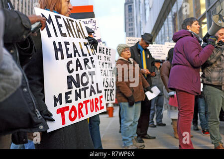 Cleveland, Ohio, USA, 11th Dec, 2018.  Protesters hold signs outside the Cuyahoga County Administration Building in downtown Cleveland, Ohio, USA prior to the council meeting addressing the inhumane conditions of the jails and the multiple deaths that have occurred to inmates over the previous six months.  Protesting address many of the issues identified by the federal inspection report by the U.S. Marshal service which found the conditions to be 'inhumane' and considered some of the worst jails in the United States. Credit: Mark Kanning/Alamy Live News Stock Photo