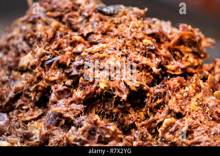 Shish kabob shredded pork barbeque bbq meat large beef pile in fast food truck counter showing macro closeup detail texture, red orange brown fresh co Stock Photo