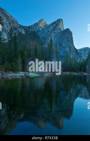 The Three Brothers reflect at morning in the Merced River in Yosemite National Park. California, USA Stock Photo