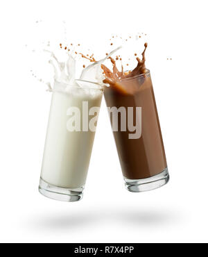 glasses full of milk and chocolate jumping and splashing on white background. Stock Photo
