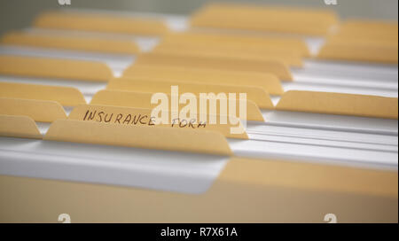 Yellow folders with labels and paper in a row Stock Photo