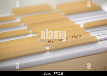 Yellow folders with labels and paper in a row Stock Photo