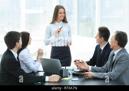 young business woman makes a report on the working meeting Stock Photo