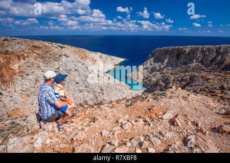 Father with his little son looking at Seitan limania beach on Crete island with azure clear water, Greece, Europe. Crete is the largest and most popul Stock Photo