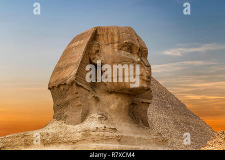 Spinx face on the Giza pyramid background at sunset, Cairo, Egypt Stock Photo