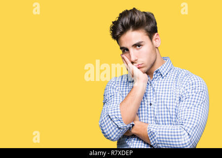 Young handsome business man over isolated background thinking looking tired and bored with depression problems with crossed arms. Stock Photo