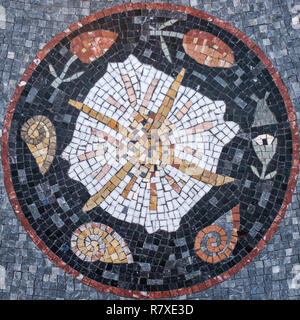 Circular Mosaic with a design at the center. Misaic Floor. Mosaic Design. Stock Photo