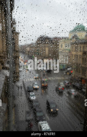 Defocussed traffic viewed through a car windscreen covered in rain Stock Photo