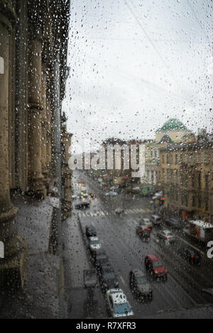 Defocussed traffic viewed through a car windscreen covered in rain Stock Photo
