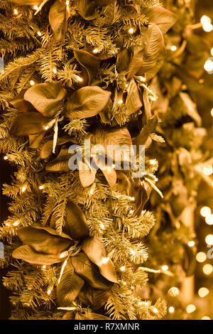 Beautiful colorful Christmas holiday backdrop image with lights, leaves and Christmas tree branches Stock Photo