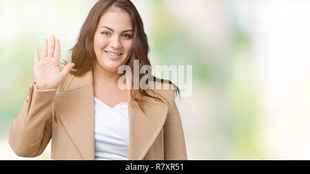 https://l450v.alamy.com/450v/r7xr51/beautiful-plus-size-young-woman-wearing-winter-coat-over-isolated-background-waiving-saying-hello-happy-and-smiling-friendly-welcome-gesture-r7xr51.jpg